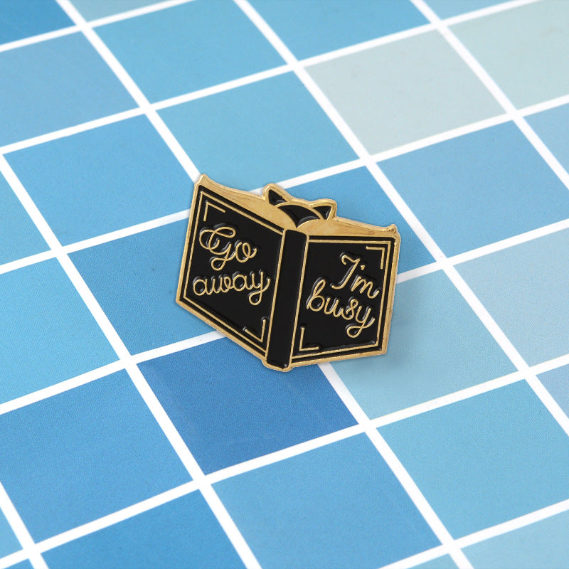 Various "Book" pins.  Brooch